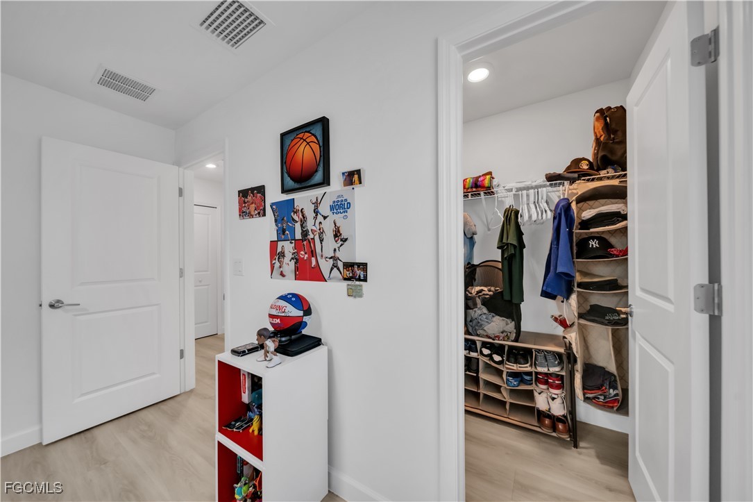 11264 Canopy Loop Fort Myers, FL 33913 - Photo 44 of 49 a view of walk in closet with clothes and shoes