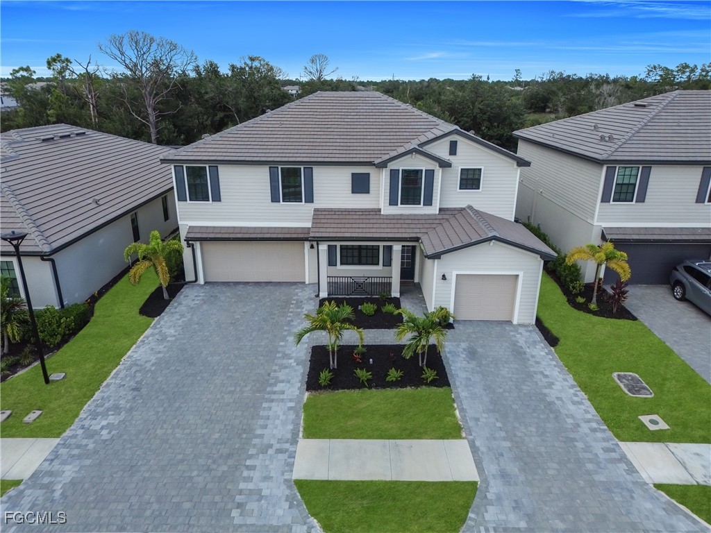 11264 Canopy Loop Fort Myers, FL 33913 - Photo 6 of 49 a front view of a house with a garden and yard