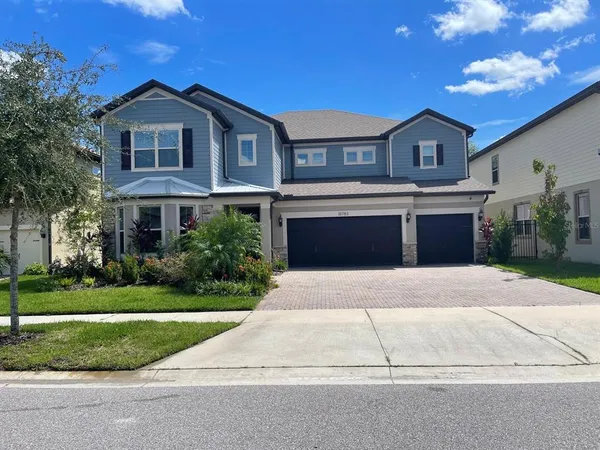 a front view of a house with a yard and garage
