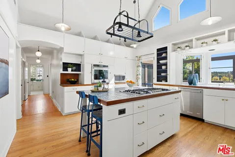 a dining room with furniture a chandelier and window