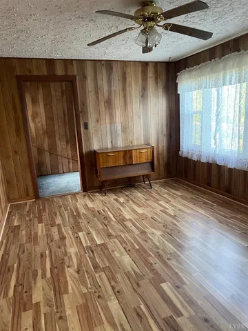 a view of a room with wooden floor and a window