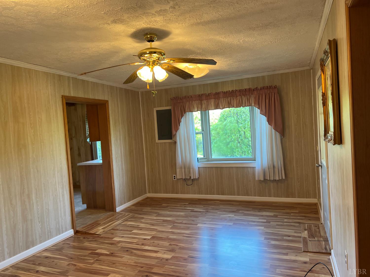 509 Riverbend Road Altavista, VA 24517 - Photo 10 of 25 a view of empty room with wooden floor and fan