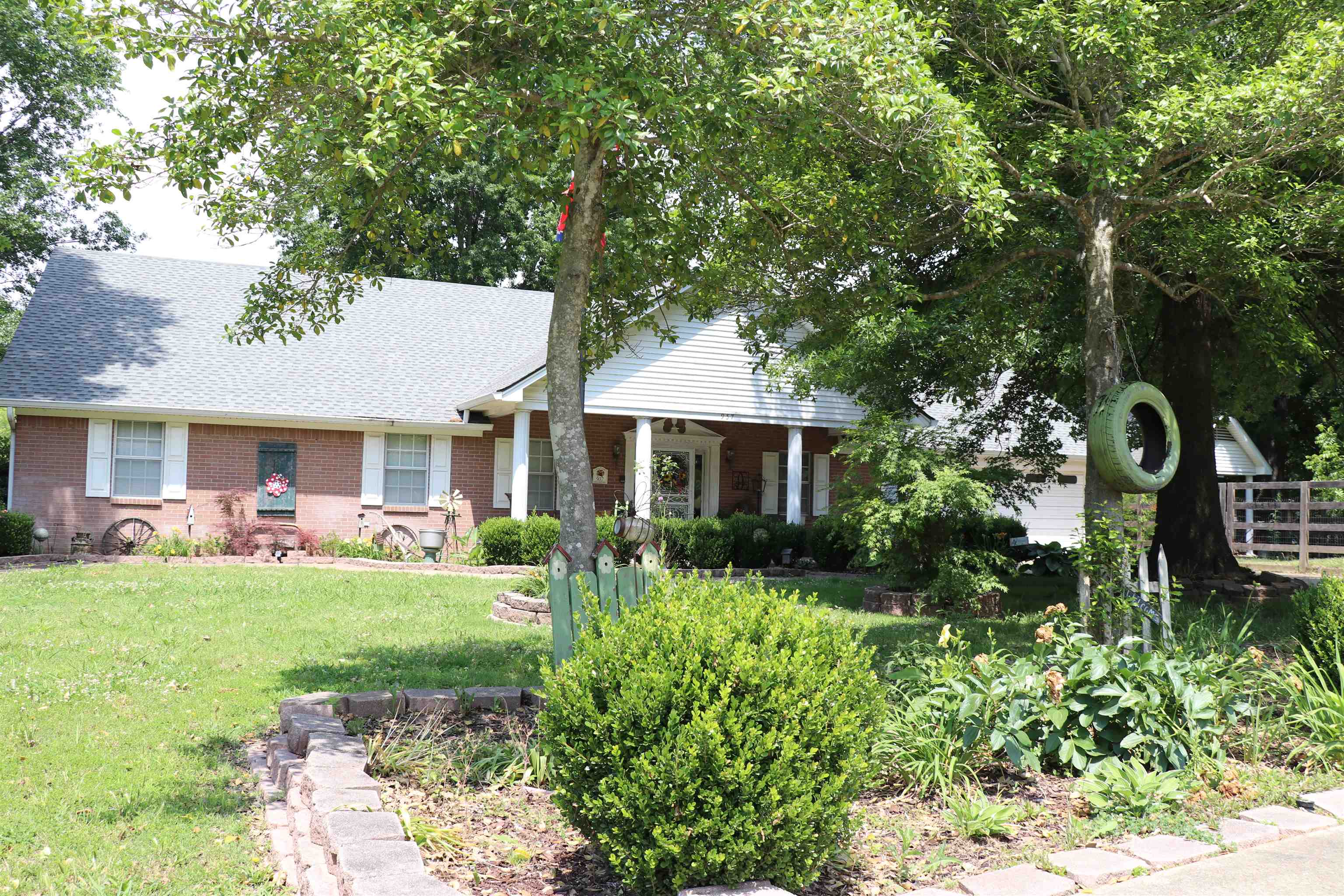 937 Kelleys Chapel Road Burlison, TN 38015 - Photo 40 of 40 Brick exterior with white shutters and a gabled roofline