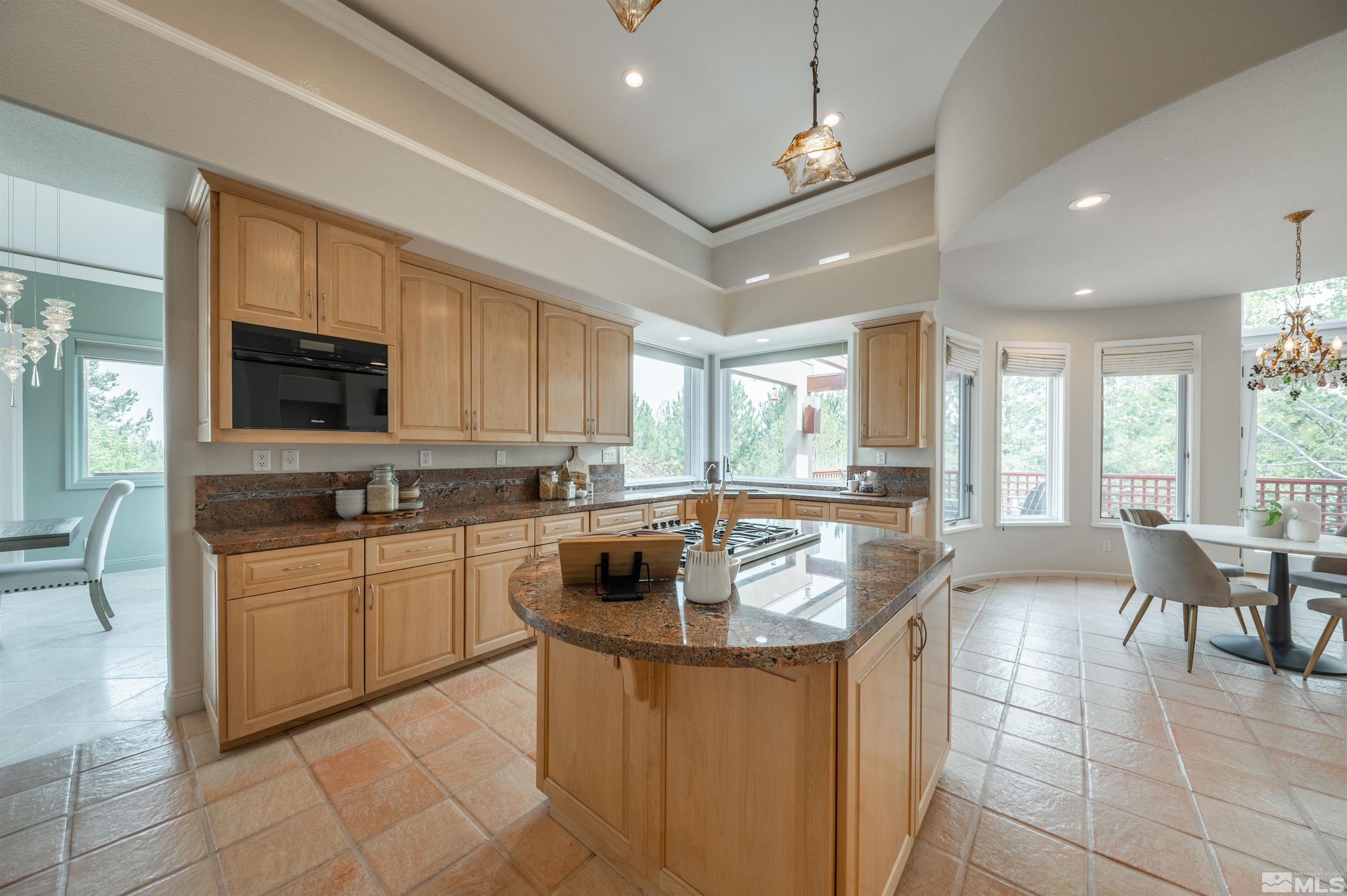 40 Sharps Circle Reno, NV 89519 - Photo 17 of 40 a kitchen with stainless steel appliances granite countertop a sink a stove a dining table and chairs