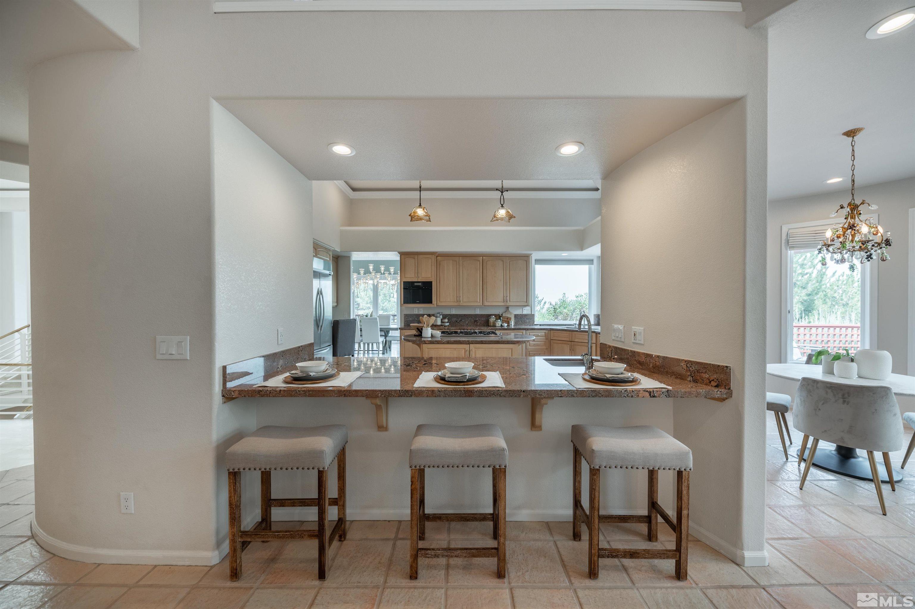 40 Sharps Circle Reno, NV 89519 - Photo 23 of 40 a kitchen with kitchen island a table and chairs in it