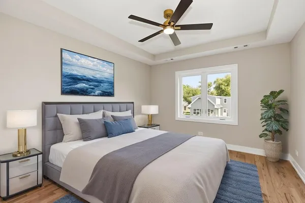 a bedroom with a large bed and a chandelier