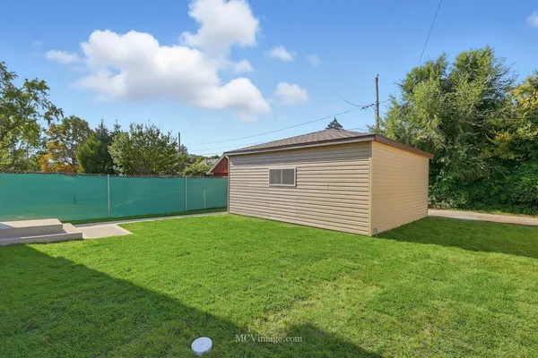 a backyard of a house with lots of green space and plants