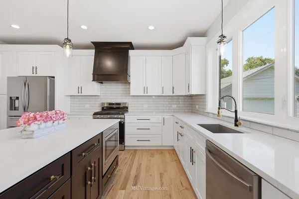 a kitchen with a sink stove and refrigerator