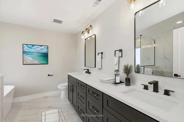 a bathroom with a double vanity sink a mirror and a