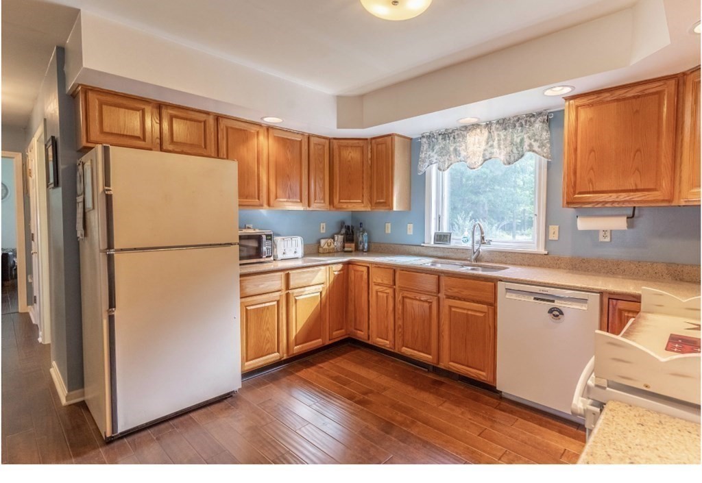 71 Papermill Road Wareham, MA 02576 - Photo 3 of 39 a kitchen with granite countertop stainless steel appliances a refrigerator a sink a cabinets and a window