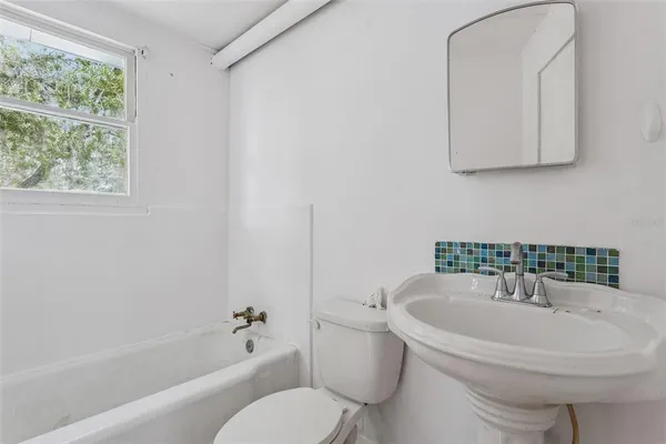 a white toilet sitting next to a bathroom sink