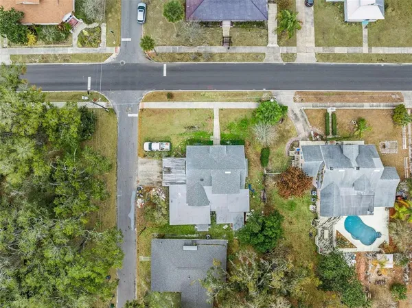 an aerial view of a house with a yard