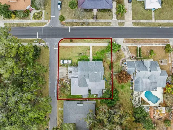 an aerial view of a house with a yard