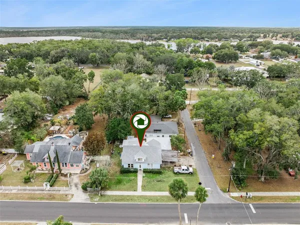 an aerial view of a house with a yard
