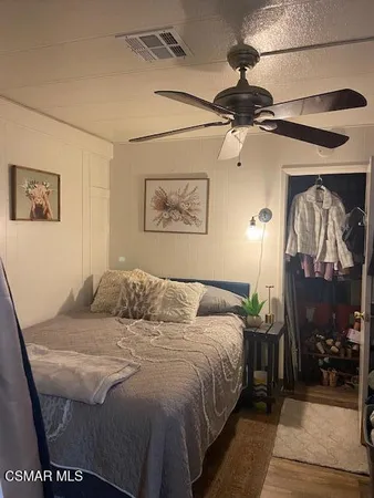 a bedroom with a bed and a mirror