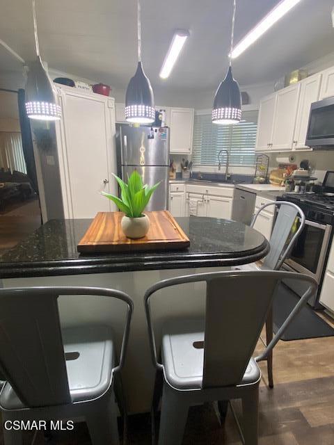 1550 Rory Lane, Unit 159 Simi Valley, CA 93063 - Photo 5 of 24 a kitchen with stainless steel appliances granite countertop a sink a stove and a refrigerator