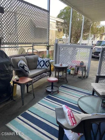 a living room with furniture and a lamp