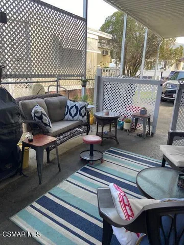 a living room with furniture and a lamp