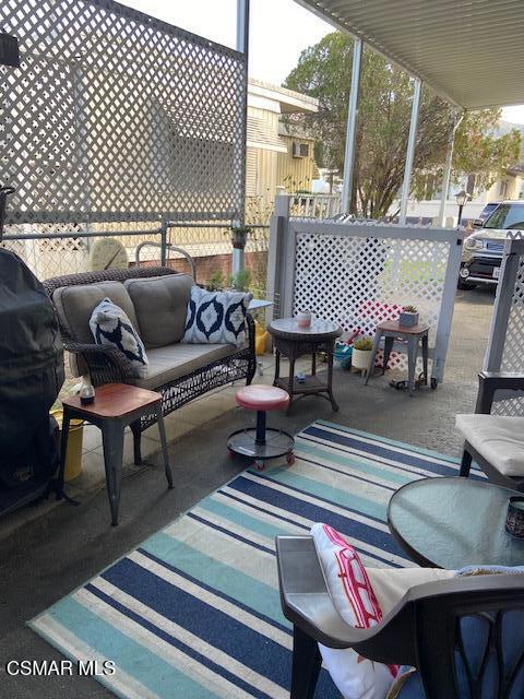 1550 Rory Lane, Unit 159 Simi Valley, CA 93063 - Photo 7 of 24 a living room with furniture and a lamp