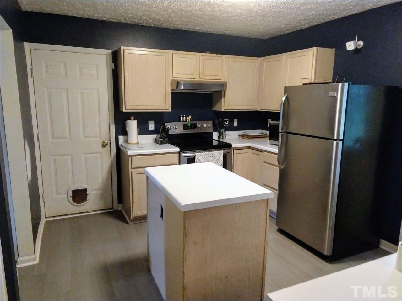 619 Parkander Court Raleigh, NC 27603 - Photo 3 of 6 a kitchen with a refrigerator a stove and a sink