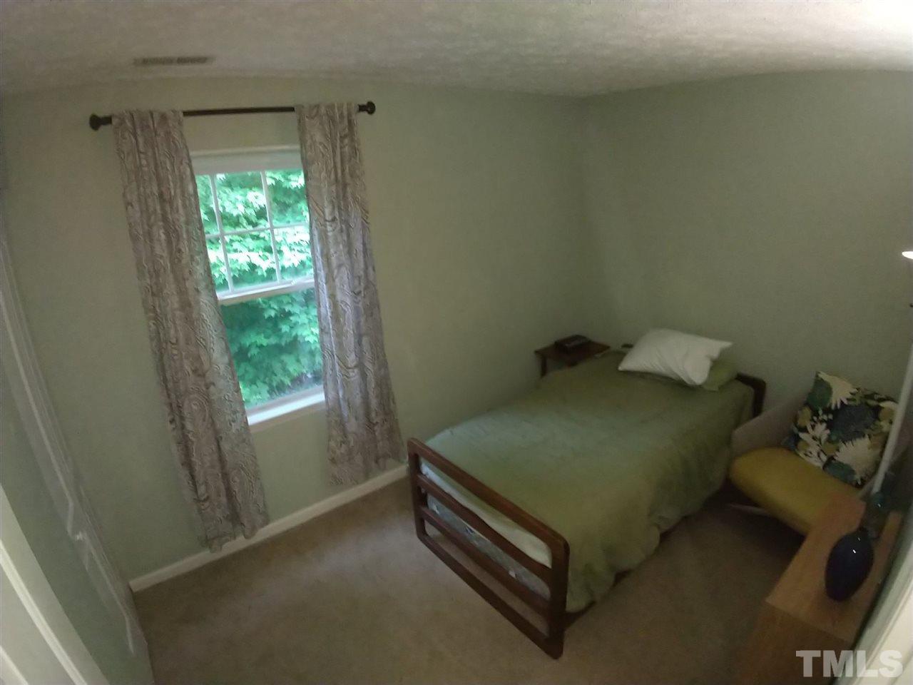619 Parkander Court Raleigh, NC 27603 - Photo 4 of 6 a bed sitting in a bedroom next to a window