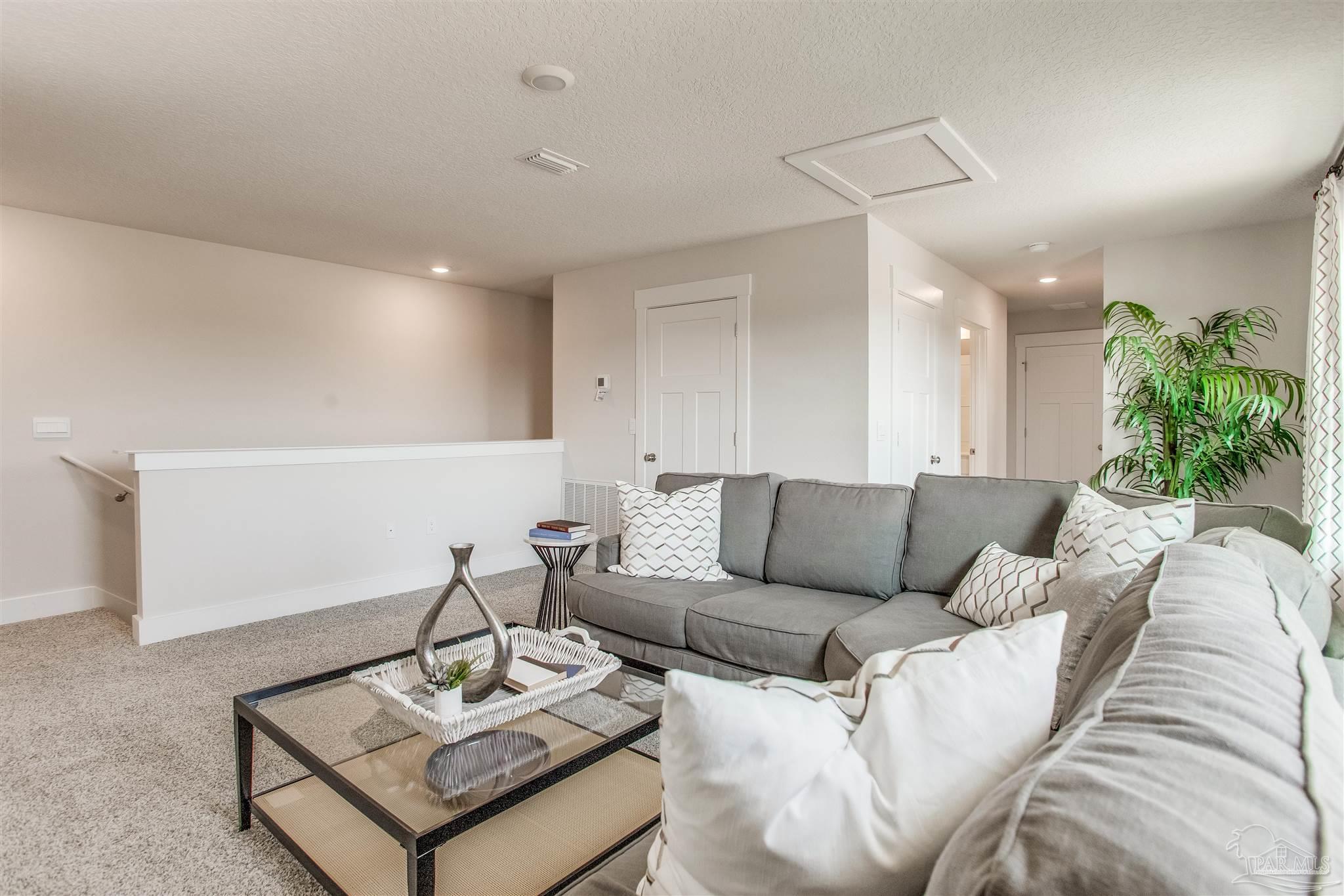 148 Albatross Street Cantonment, FL 32533 - Photo 21 of 31 a living room with furniture and wooden floor