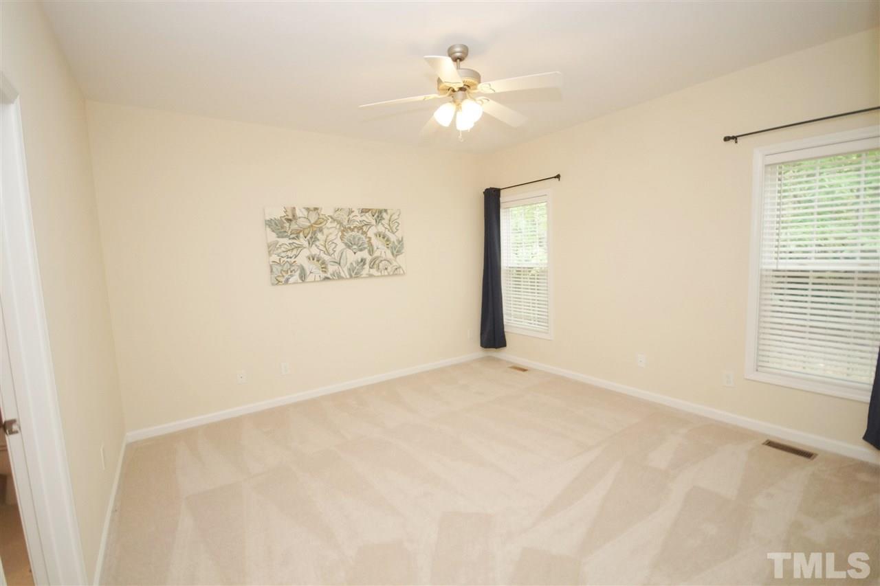 5209 Groveside Court Raleigh, NC 27613 - Photo 13 of 25 an empty room with windows and fan