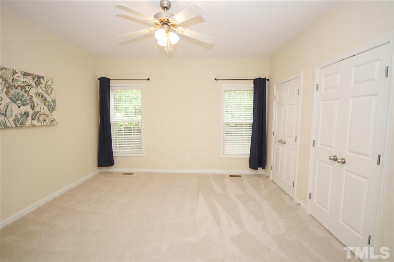5209 Groveside Court Raleigh, NC 27613 - Photo 14 of 25 an empty room with windows and fan
