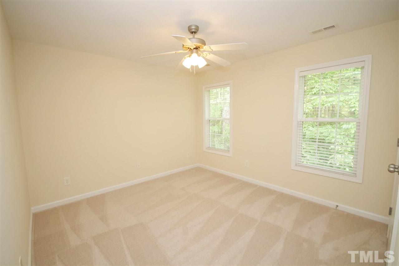 5209 Groveside Court Raleigh, NC 27613 - Photo 17 of 25 an empty room with a window and a fan