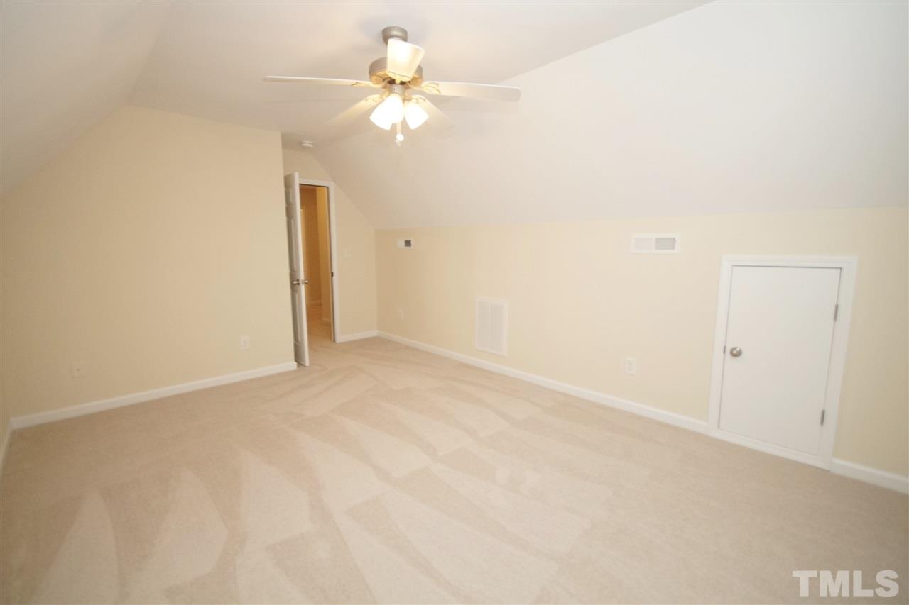 5209 Groveside Court Raleigh, NC 27613 - Photo 21 of 25 an empty room with a chandelier fan and closet