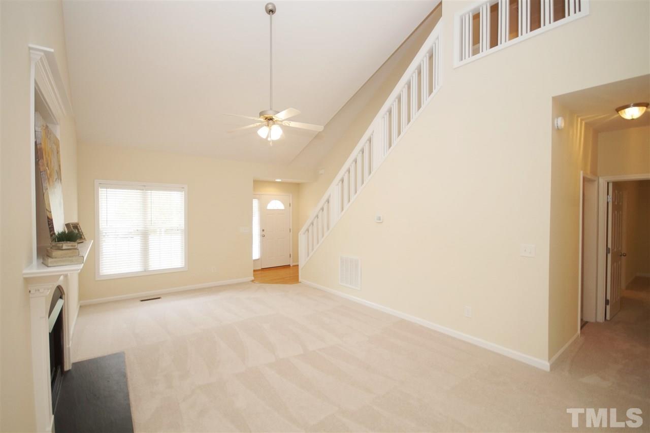 5209 Groveside Court Raleigh, NC 27613 - Photo 7 of 25 a view of an empty room with a fireplace and a window