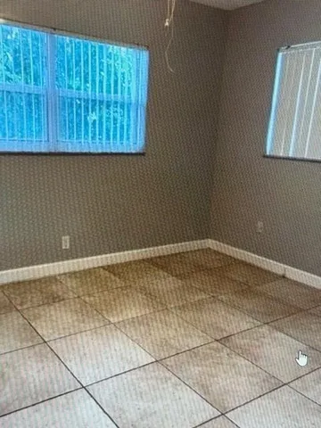 a view of a room with a wooden door