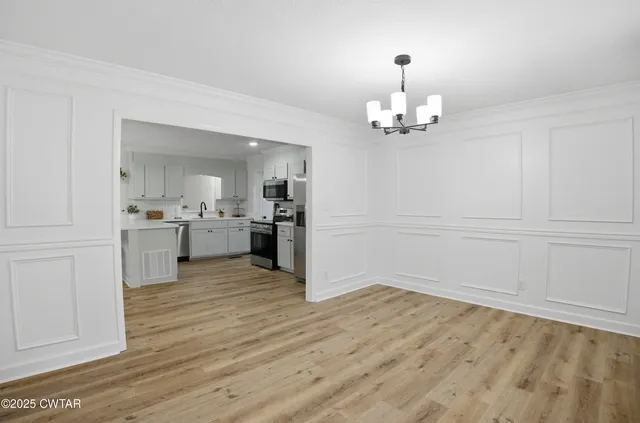 a view of a kitchen with wooden floor and a kitchen