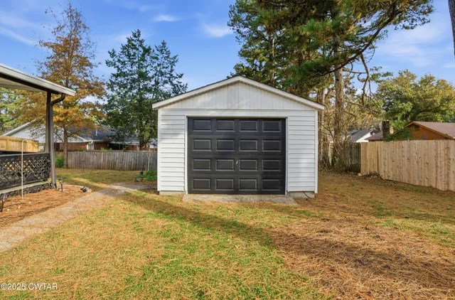 a view of a house with a yard and garage