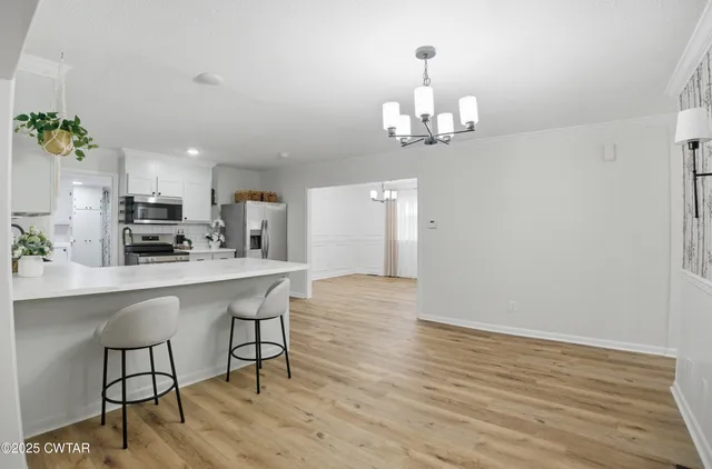 a kitchen with stainless steel appliances granite countertop a stove refrigerator and microwave