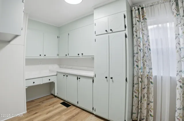 a view of a storage and utility room with closet