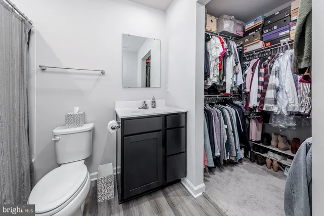 a bathroom with a toilet a sink and a mirror