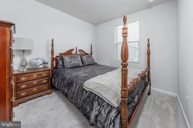 a bed room with a bed and a night stand