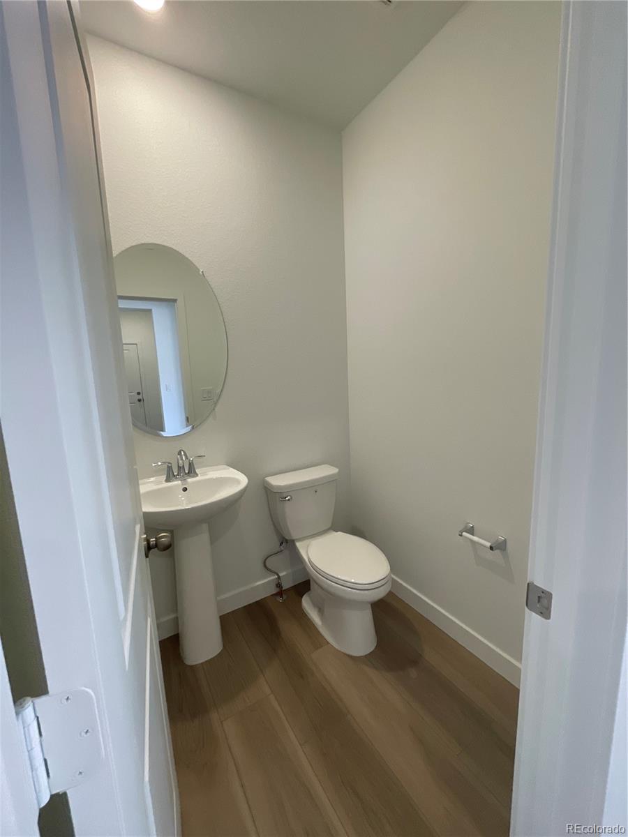 12883 Range Street Firestone, CO 80504 - Photo 11 of 39 a white toilet sitting next to a bathroom sink