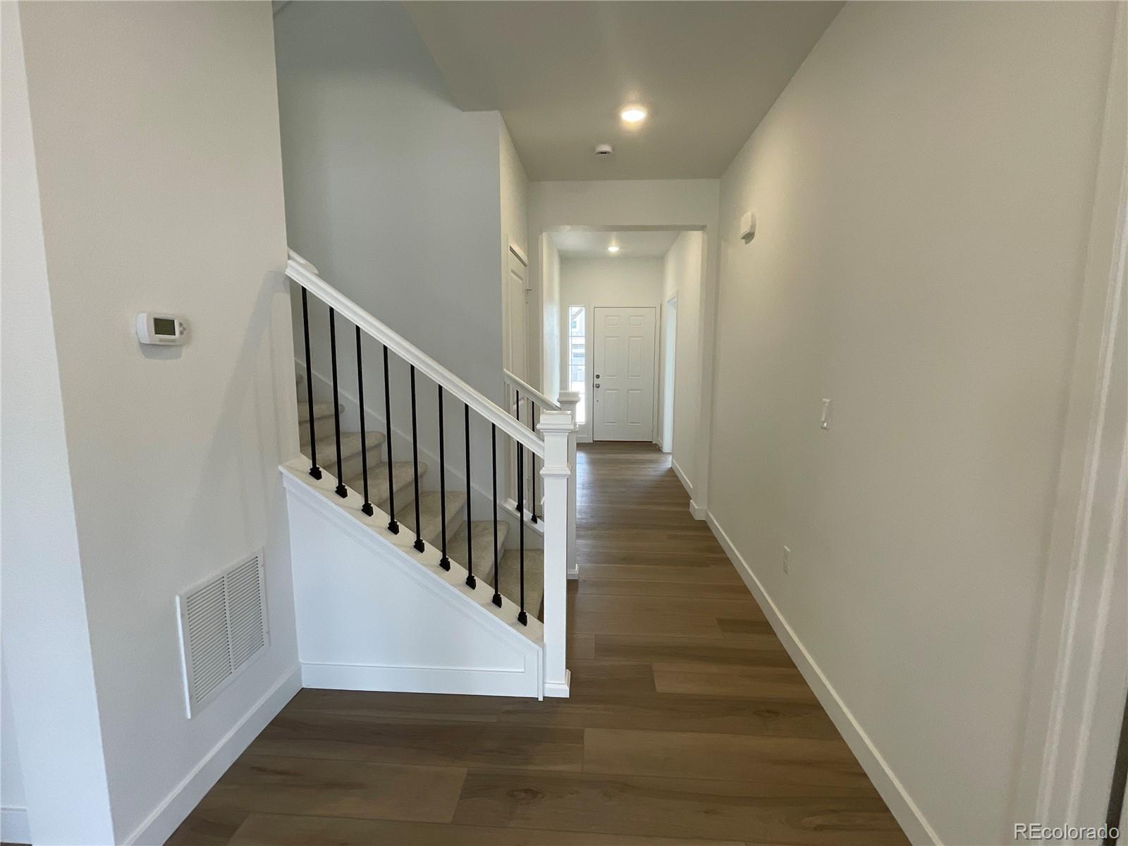 12883 Range Street Firestone, CO 80504 - Photo 12 of 39 a view of a hallway with the wooden floor