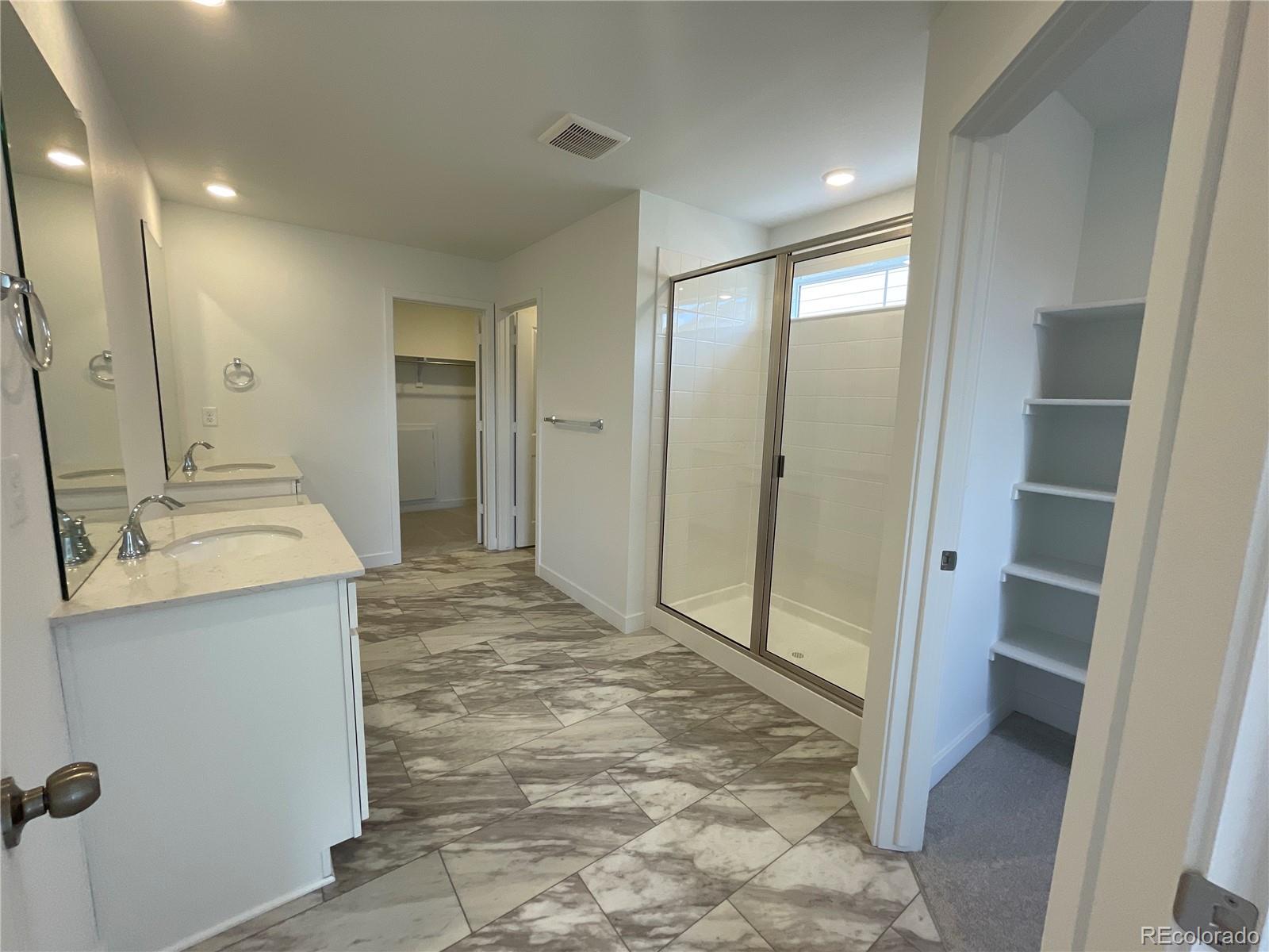 12883 Range Street Firestone, CO 80504 - Photo 16 of 39 a bathroom with a granite countertop sink and a mirror