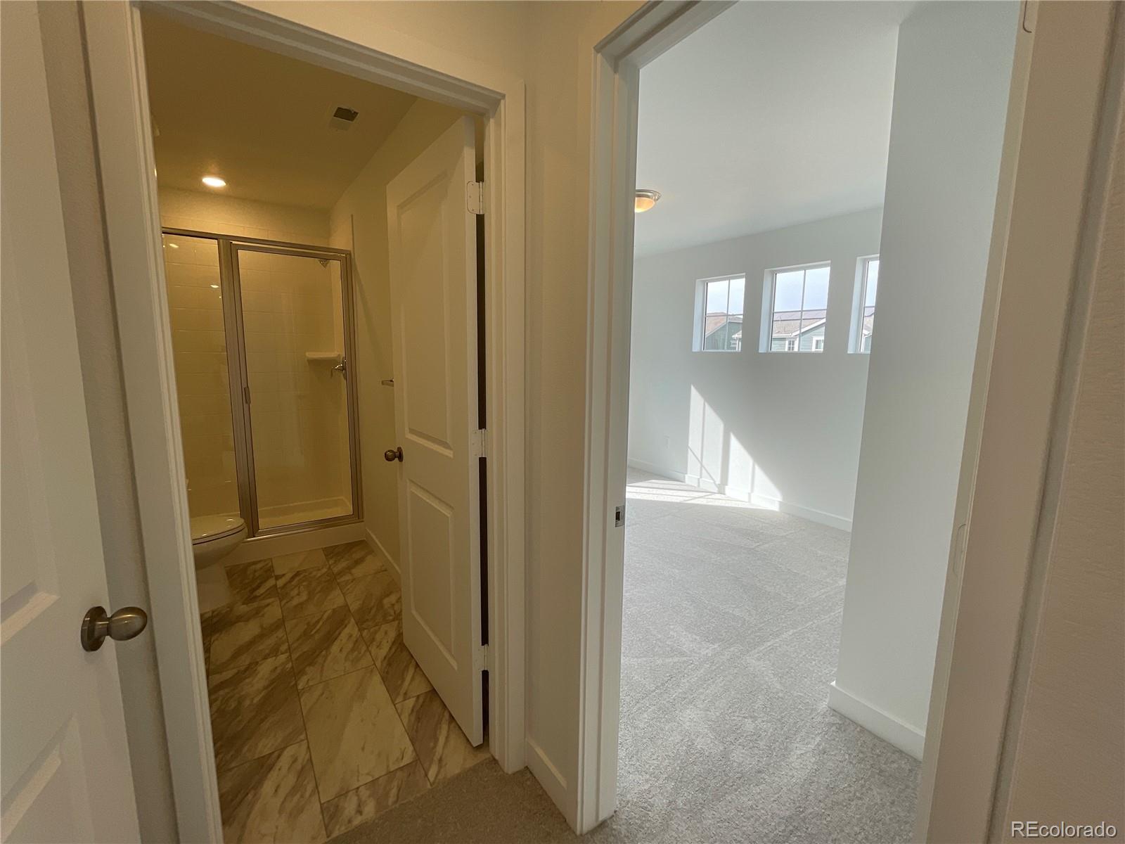 12883 Range Street Firestone, CO 80504 - Photo 18 of 39 a view of a bathroom from a hallway