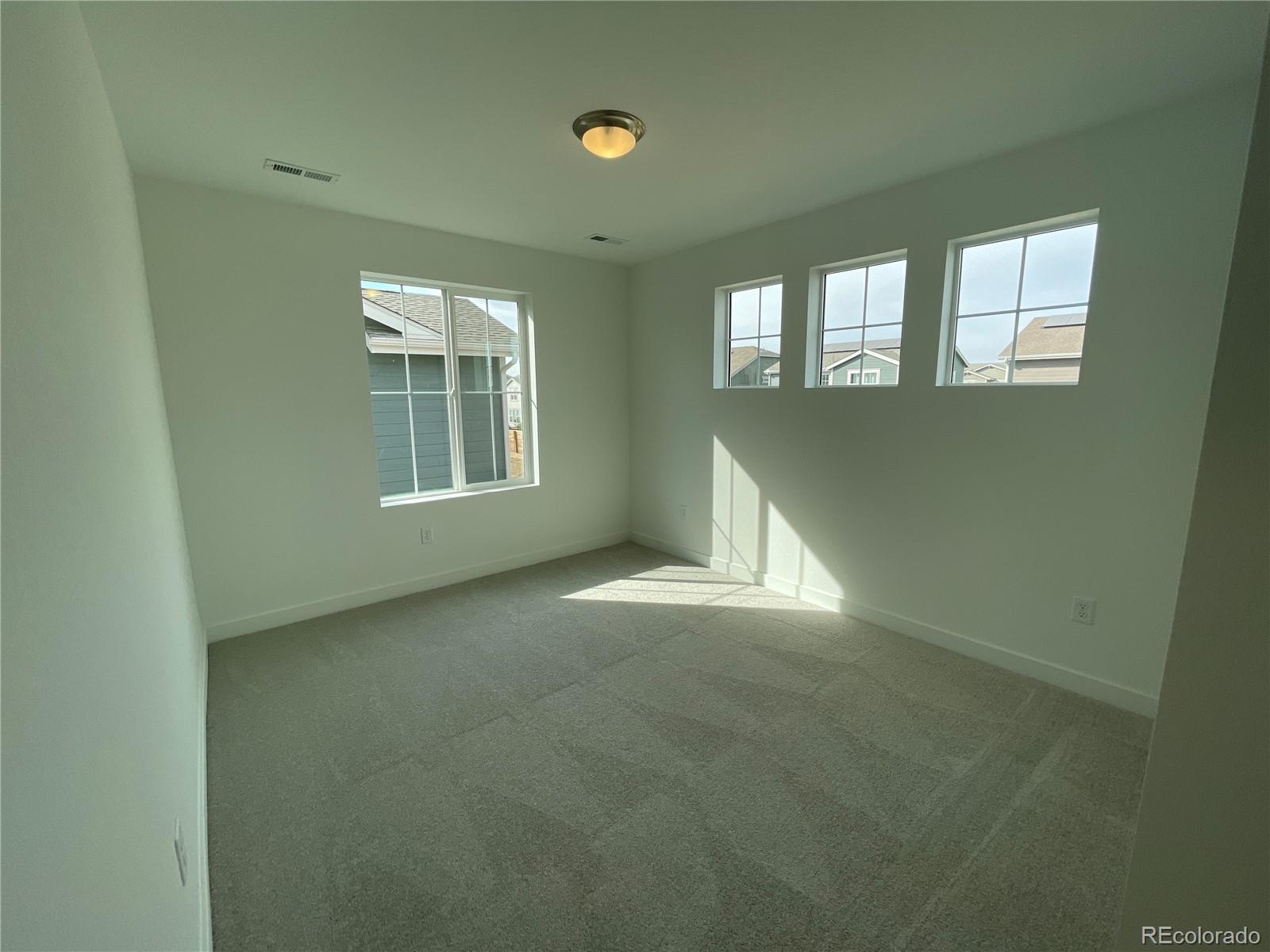 12883 Range Street Firestone, CO 80504 - Photo 19 of 39 an empty room with windows