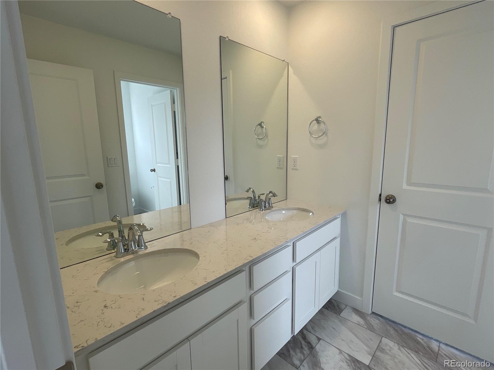 12883 Range Street Firestone, CO 80504 - Photo 20 of 39 a bathroom with a granite countertop sink and a mirror