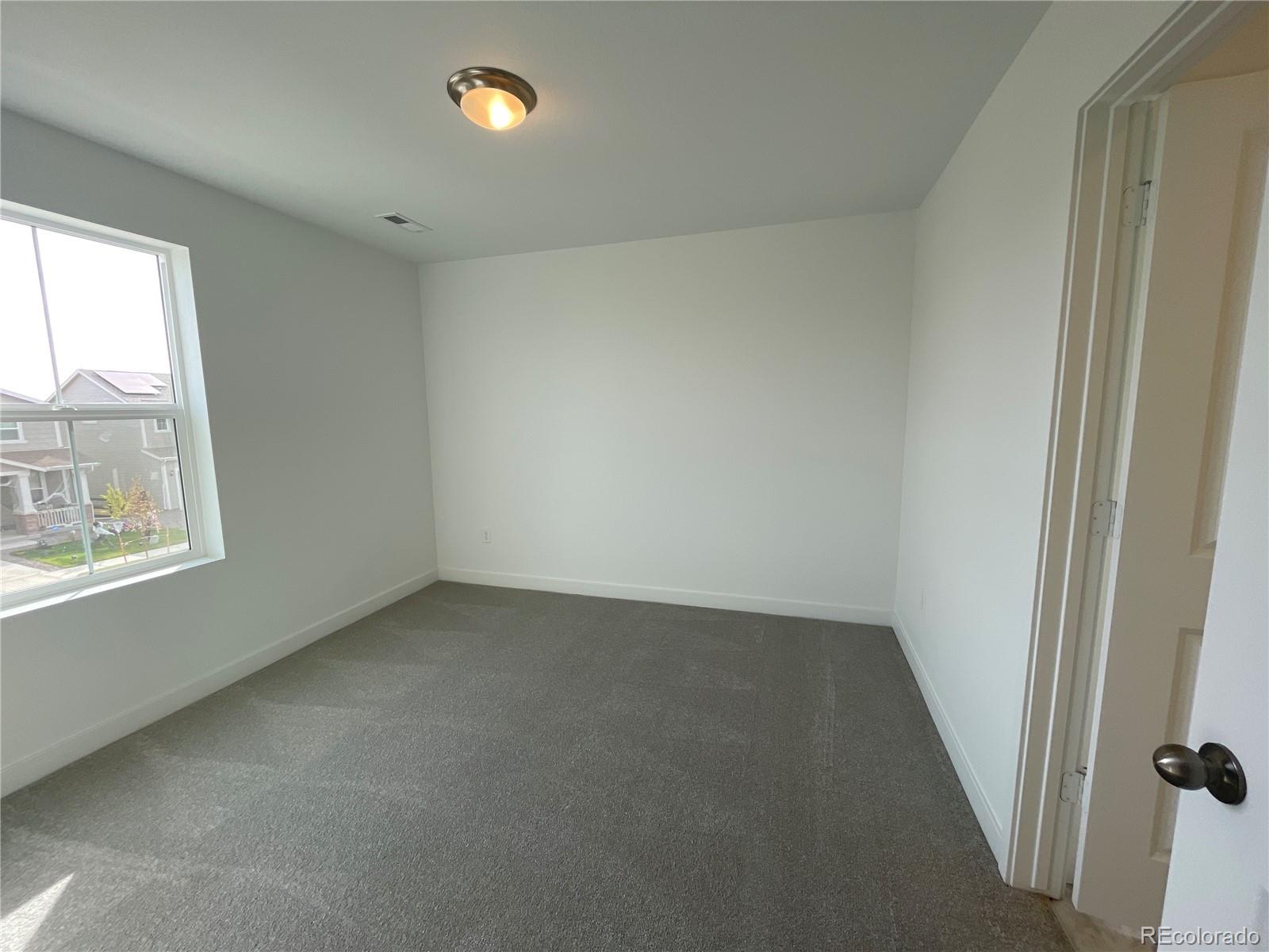12883 Range Street Firestone, CO 80504 - Photo 23 of 39 an empty room with a window