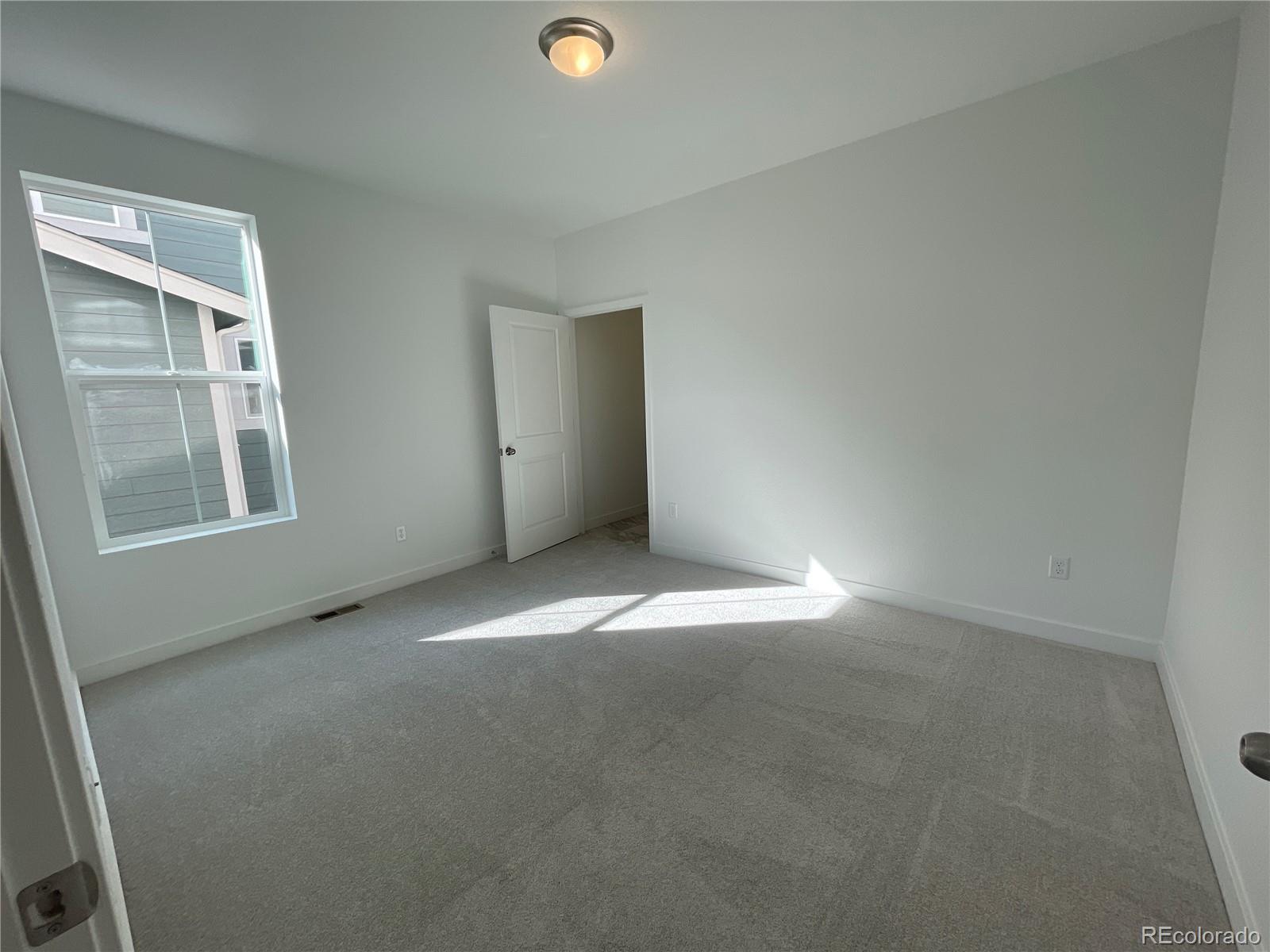 12883 Range Street Firestone, CO 80504 - Photo 24 of 39 an empty room with windows