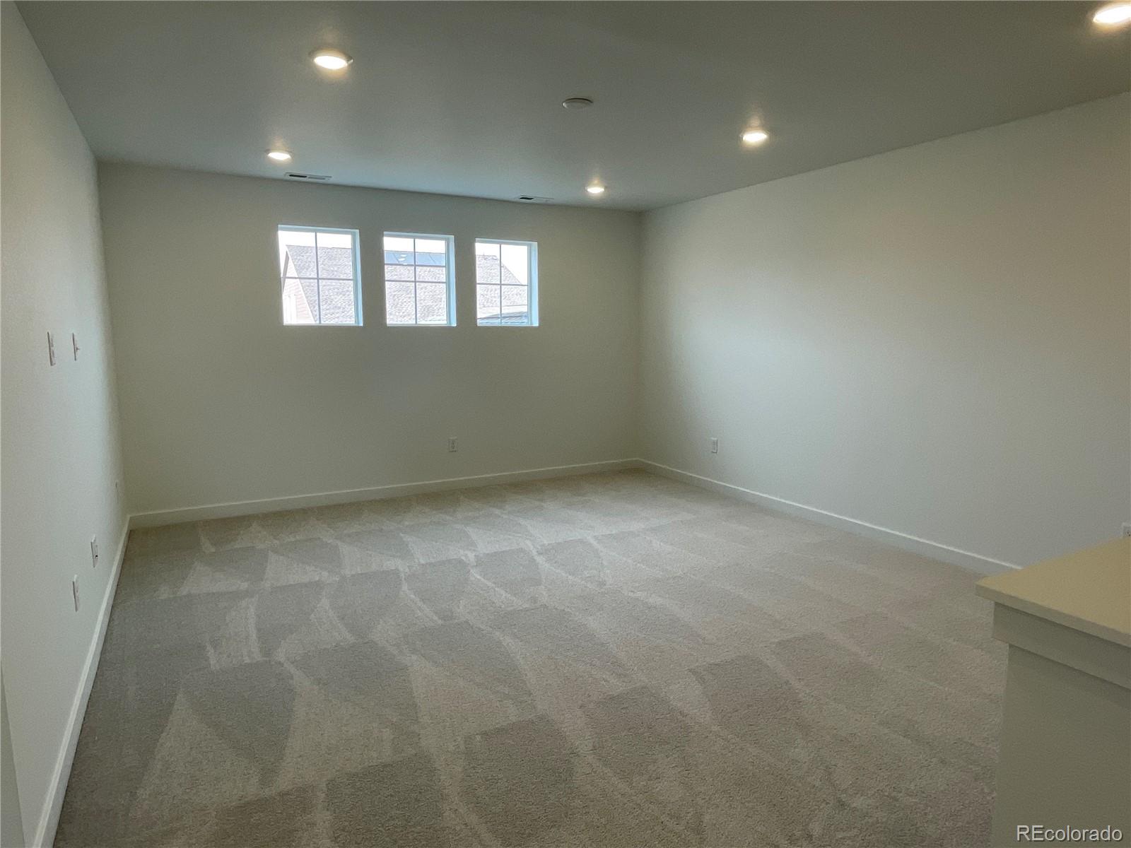 12883 Range Street Firestone, CO 80504 - Photo 8 of 39 an empty room with windows