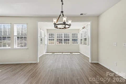 a view of wooden floor and windows in a room