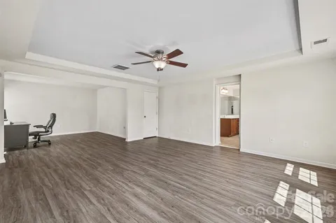 a view of workspace with wooden floor and ceiling fan