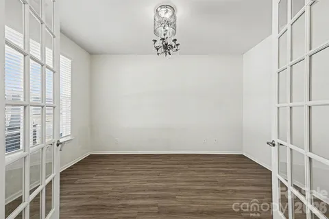 a view of a livingroom with wooden floor and a window